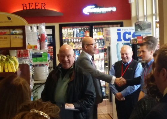 Mayor Hagen speaking at Ribbon Cutting ceremony today at Hammond Avenue Kwik Trip. Chamber President David Minor is shown shaking hands, while Don Zeitlow smiles at the camera | Explore Superior©