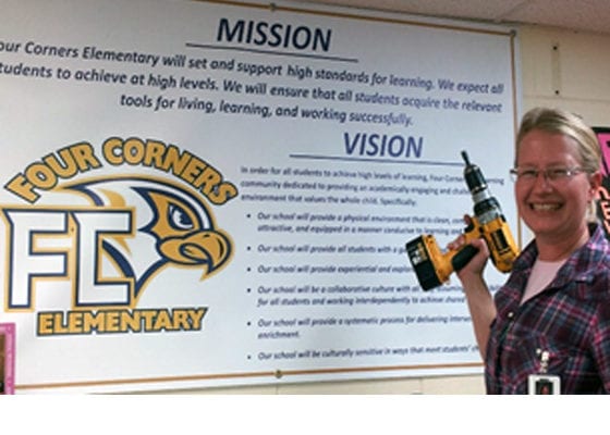 Ms Constance Putting up Mission and Vision Banner at Four Corners Elementary School | Explore Superior©